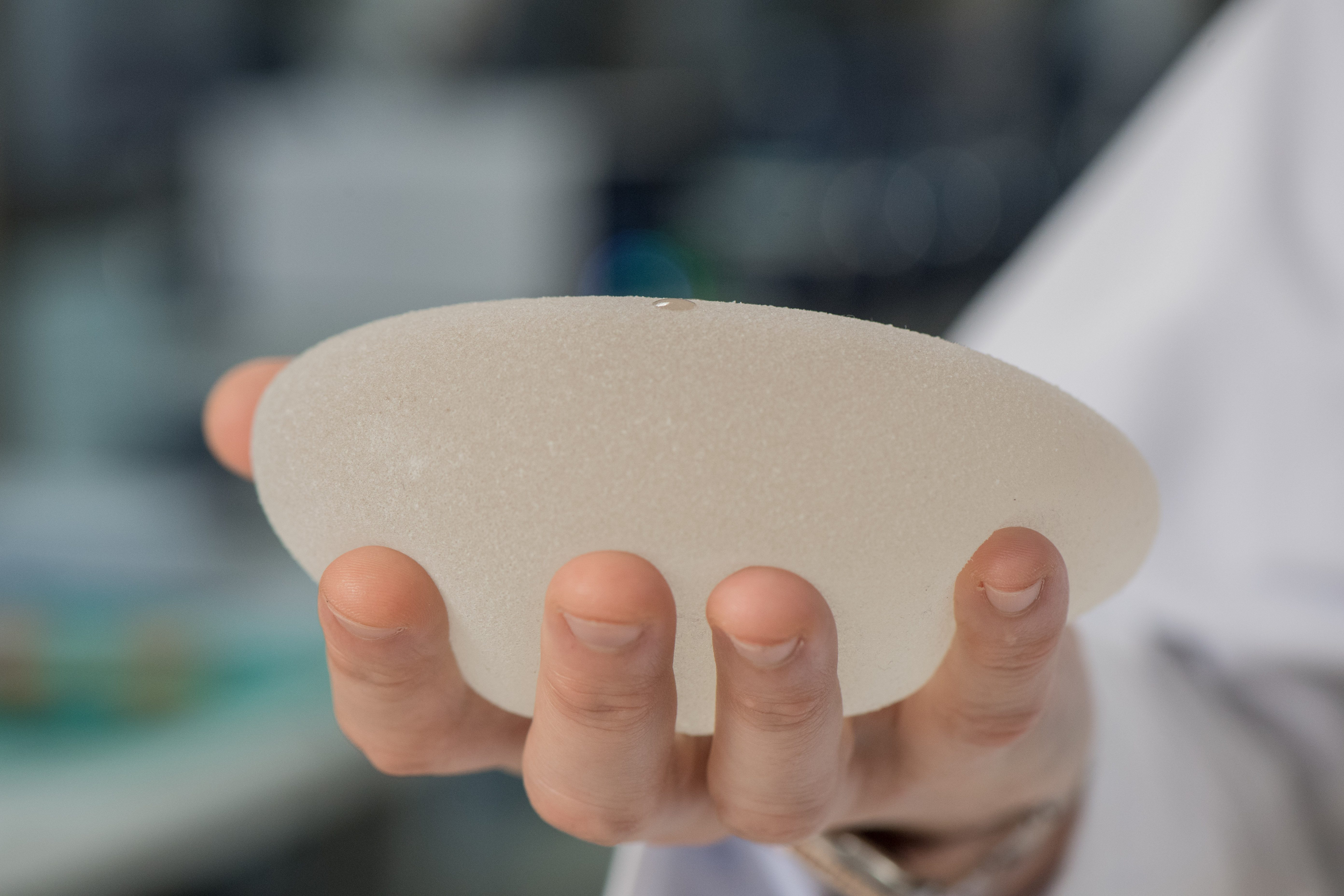Mark Clemens, M.D., holds a silicone breast implant.