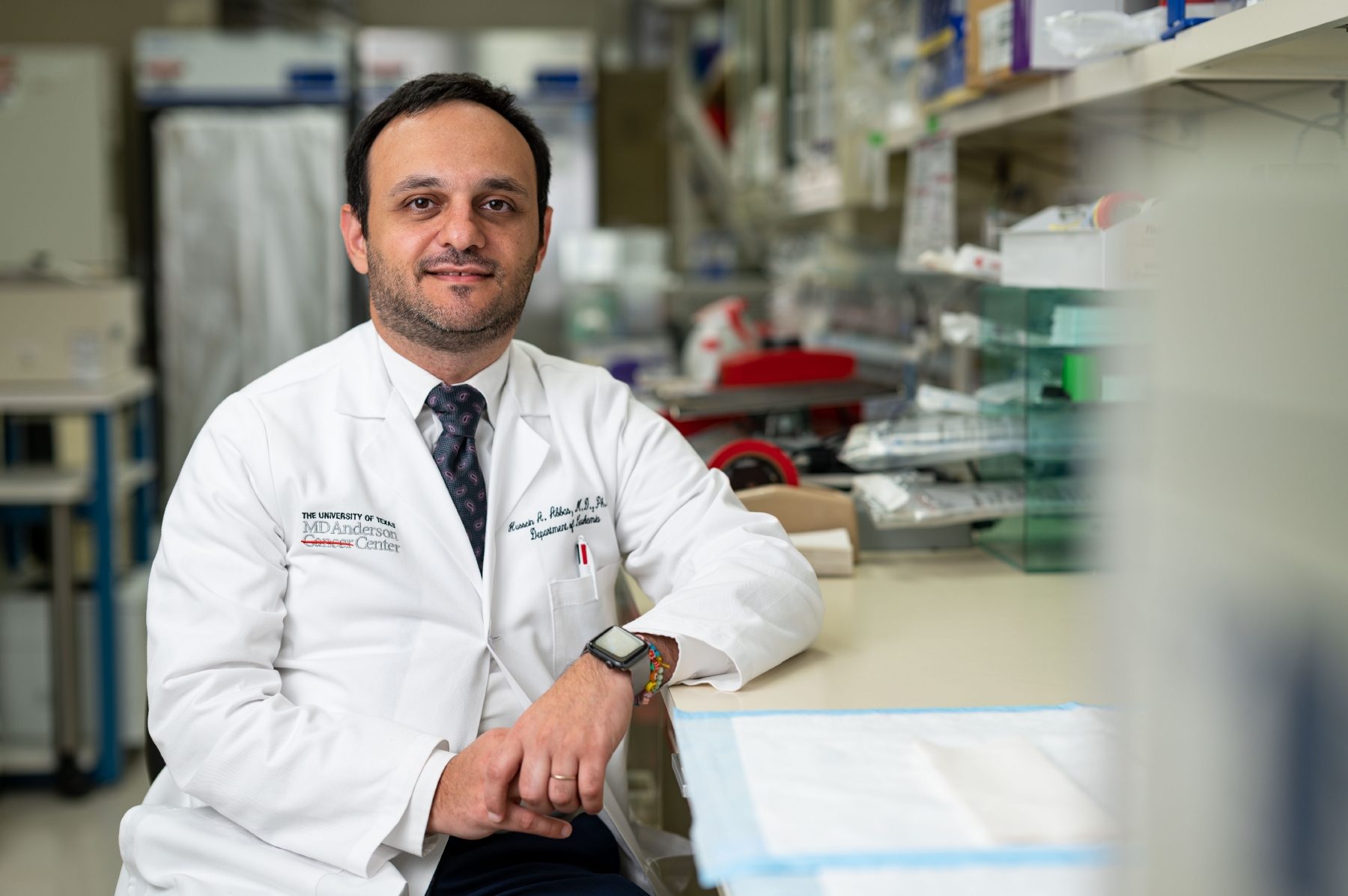 Hussein Abbas, M.D., Ph.D., sits in his lab