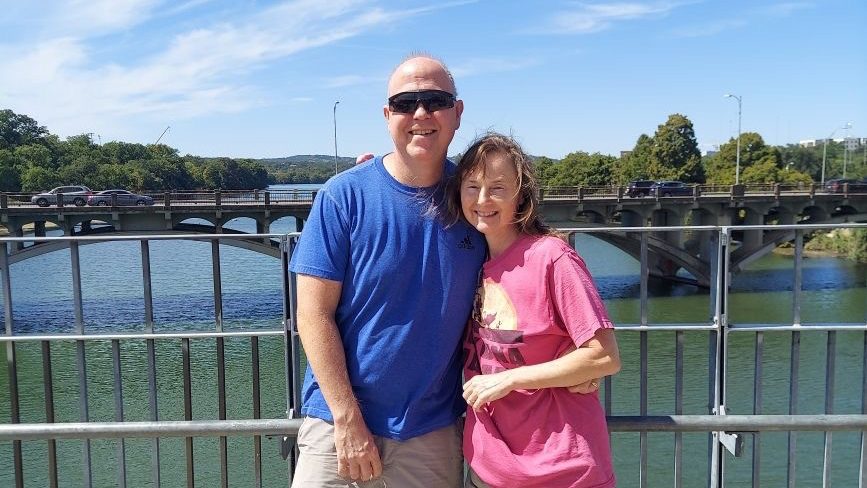 John and Lynnette Davis pose for a picture on a bridge