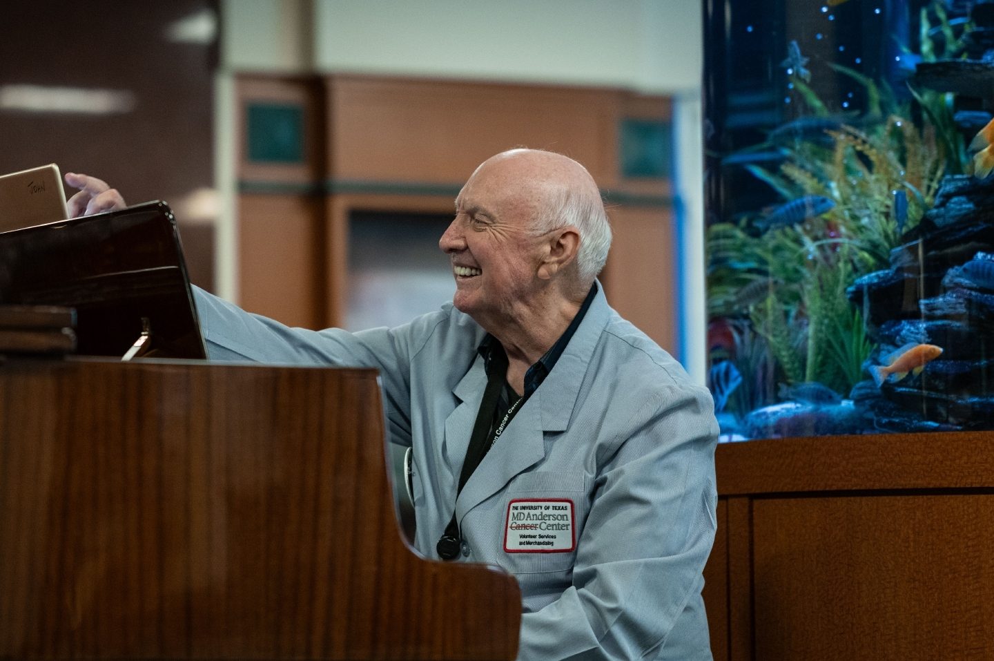 Longtime MD Anderson volunteer John Dunsmoir, 81, leaves his home in Austin at 2 a.m. every Friday to drive to Houston for his volunteer shift in the surgery waiting area. Dunsmoir also frequents the pianos around MD Anderson and is a regular fixture walking the skybridge between buildings for extra exercise.