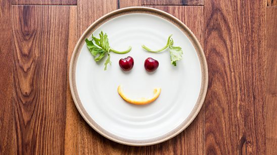 Plate with fresh food positioned to create a smiling face