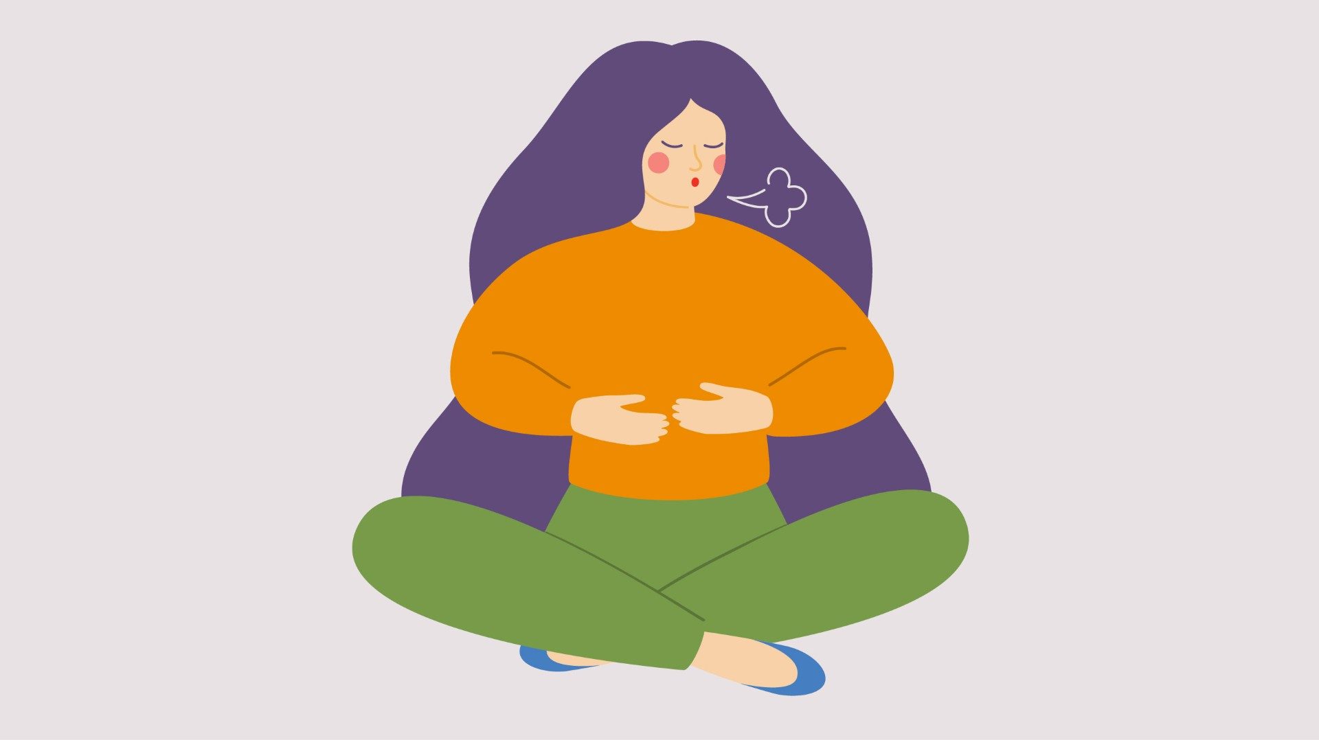 A woman wearing an orange shirt and green pants sits cross-legged with her hands on her stomach. A small puff of air exits her mouth.