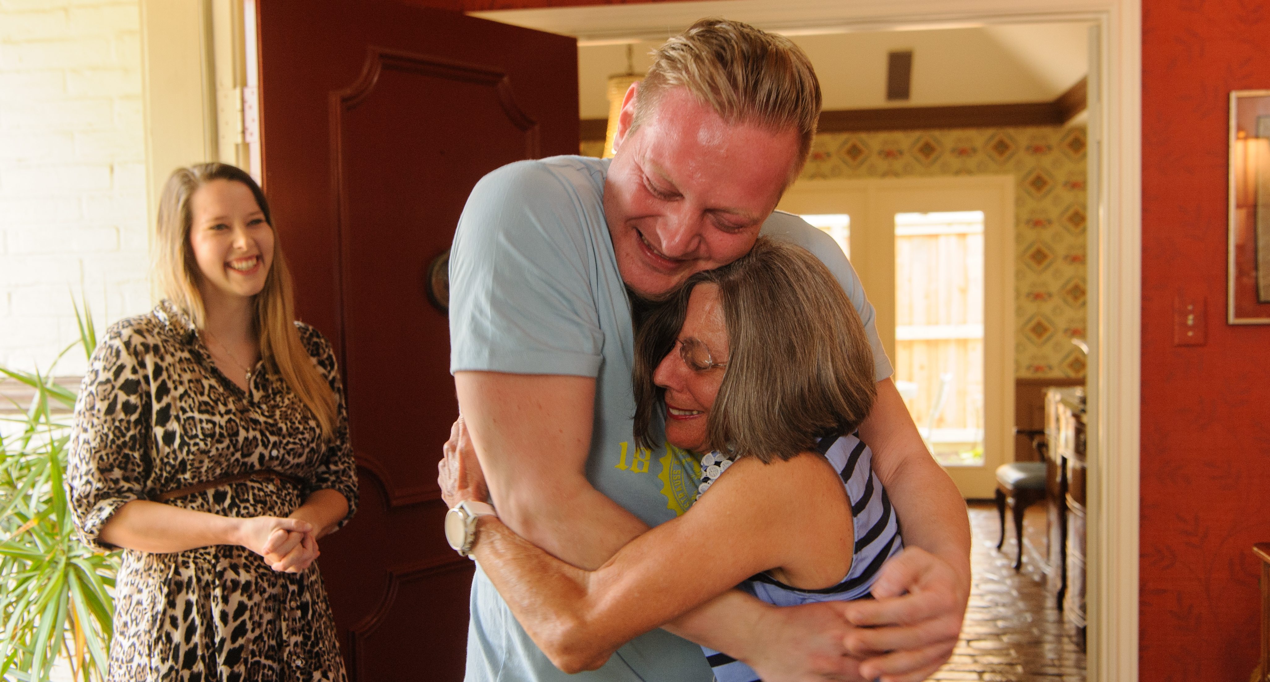 Ticia Hanisch hugs her stem cell donor, Dominik Braudenburg, while his wife, Melina Maurer, looks on.