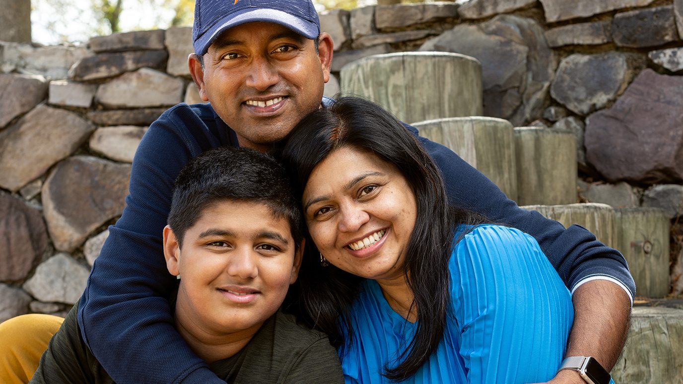 Leukemia survivor Arav Patil with his parents, Komal (right) and Rahul, who has his arms around Arav and Komal