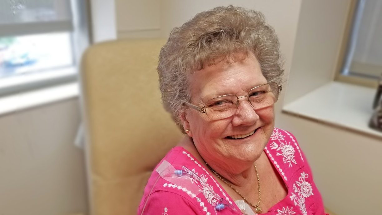 Colorectal cancer survivor June Graham smiles as she receives maintenance chemotherapy