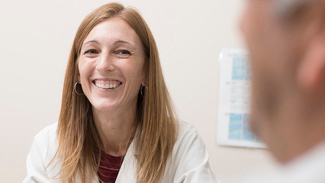 Courtney DiNardo, M.D., speaks with a patient