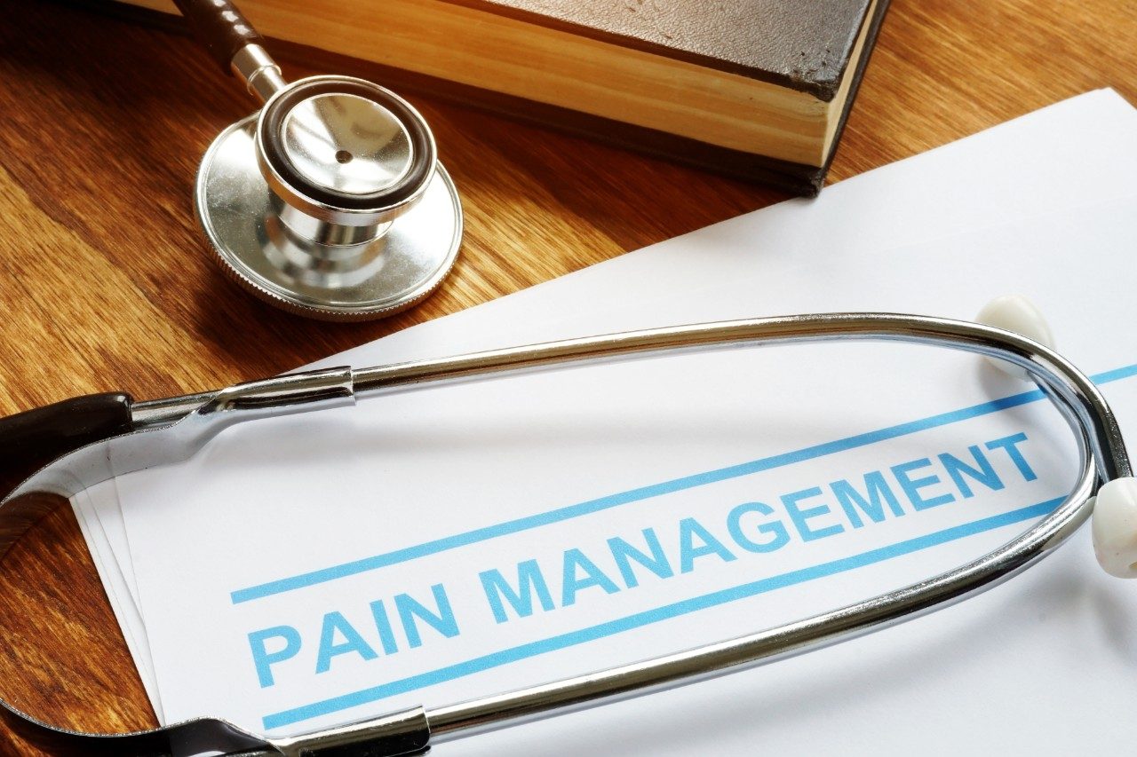 Stethoscope and paper with pain management on it
