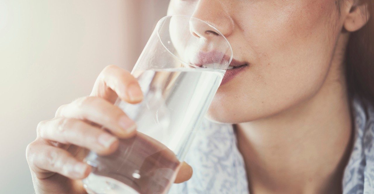 Woman drinking from a glass of water