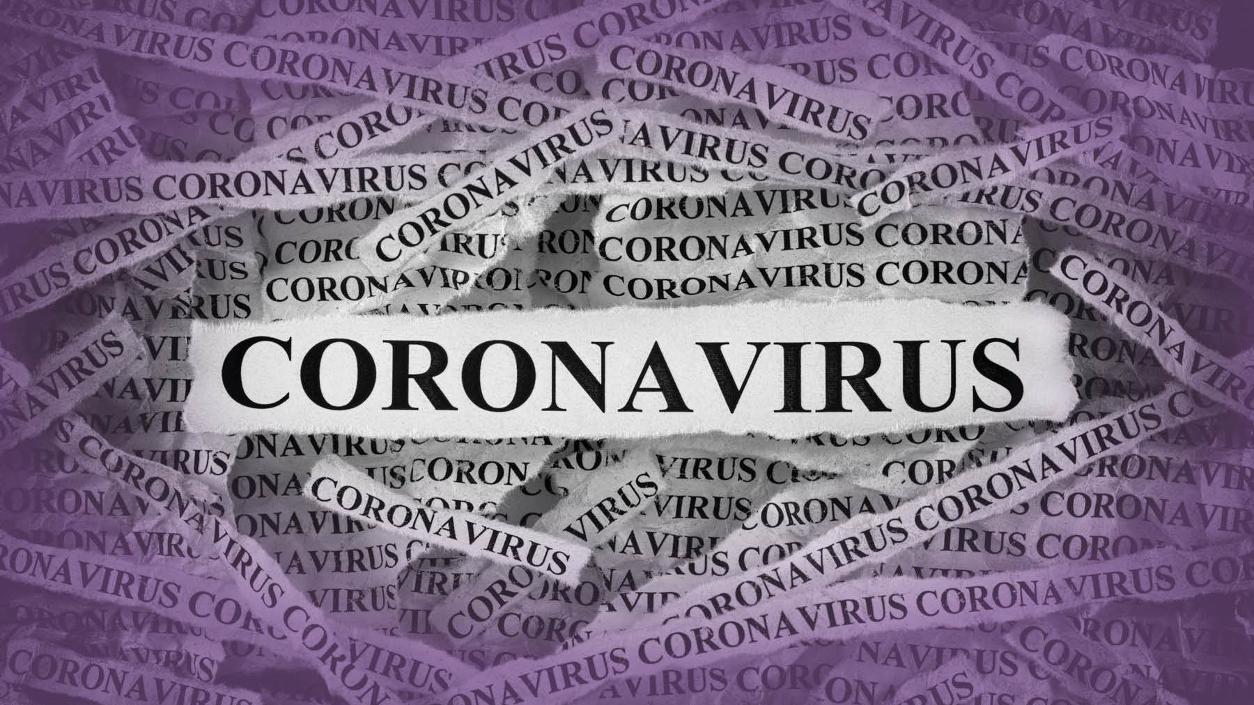 Dozens of strips of torn paper with "coronavirus" typed on them