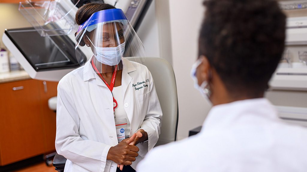 Megan Kalambo, M.D., speaks with a patient 