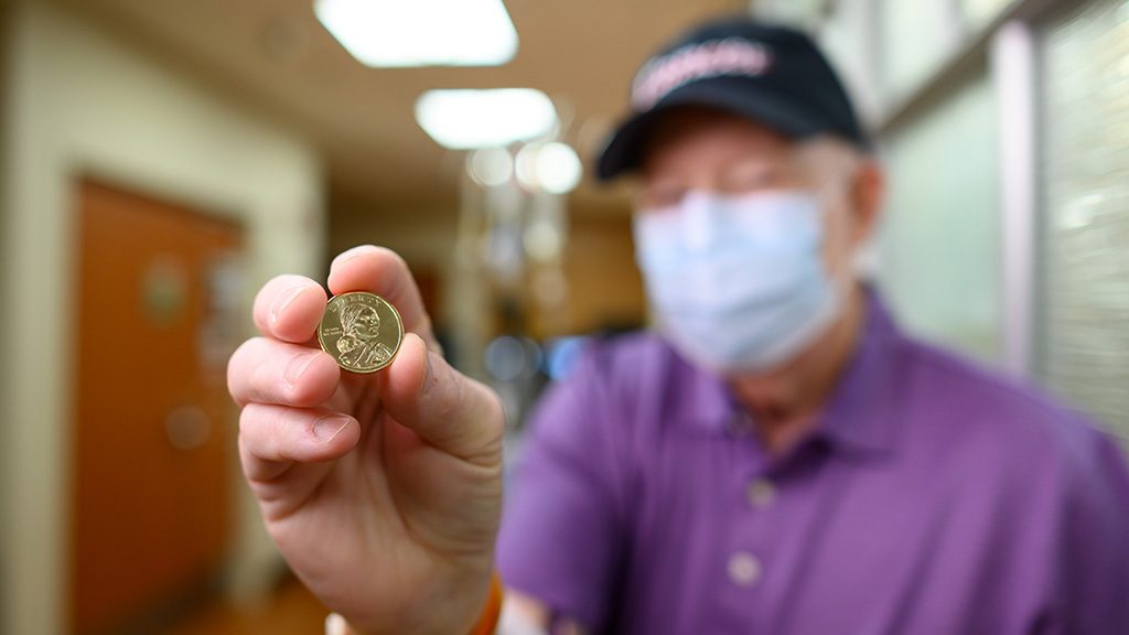 Myelodysplastic syndrome survivor Chris Golding, holding a Sacagawea coin