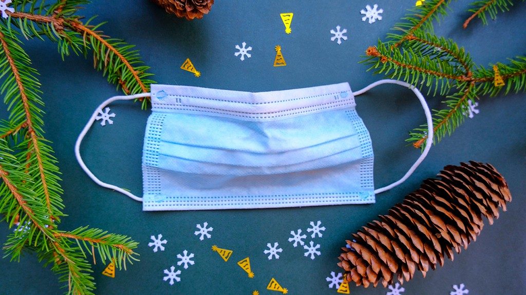 Medical face mask on festive holiday background