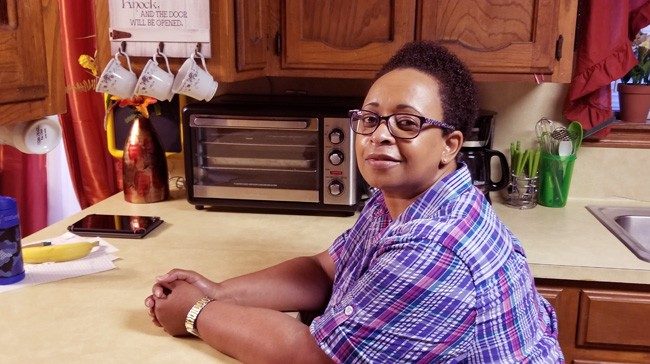 Trena Robertson sitting at her kitchen counter
