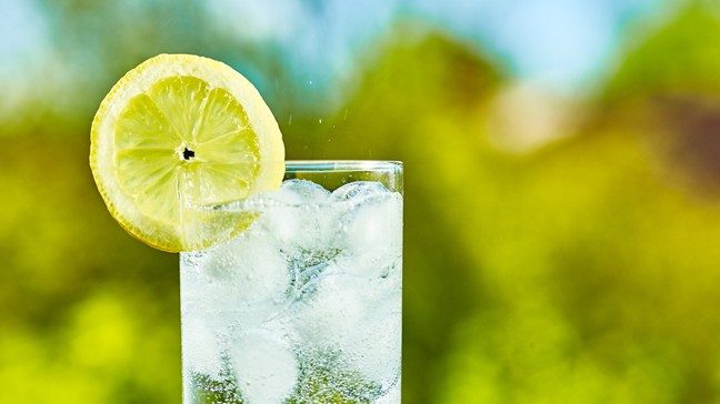 glass of sparkling water with a lemon wedge
