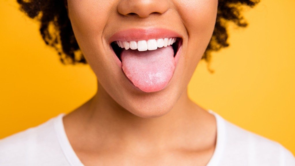 Woman smiling with mouth open and tongue out
