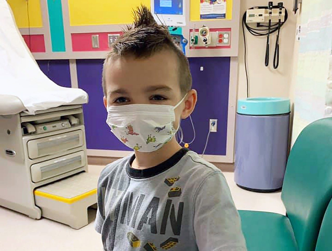 Embryonal rhabdomyosarcoma survivor Sawyer Hack, pictured in a face mask