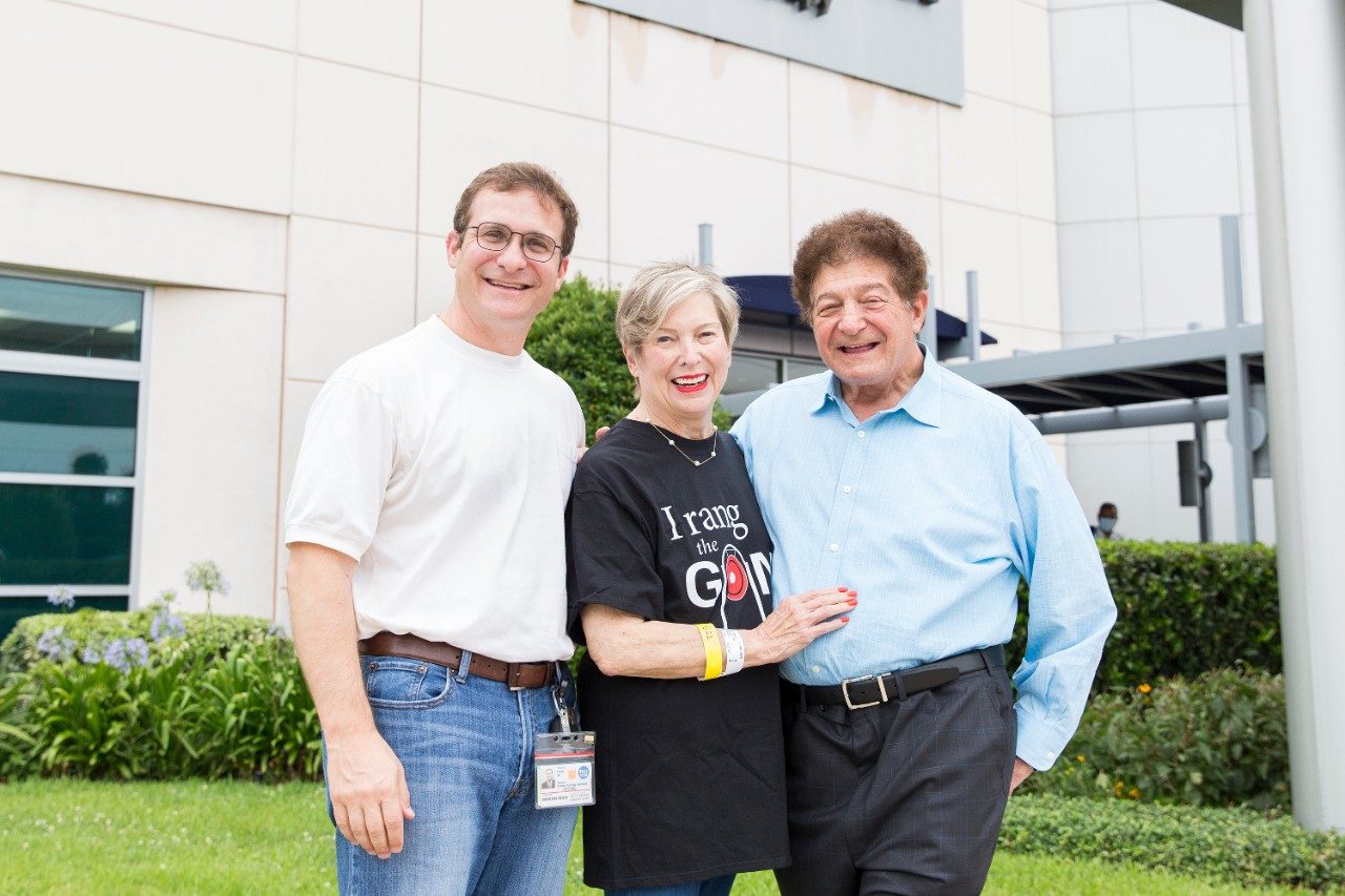 Cookie Frank stands outside MD Anderson Proton Therapy Center with her son, Steven Frank , M.D.,  and her husband, Milton Frank III, M.D.