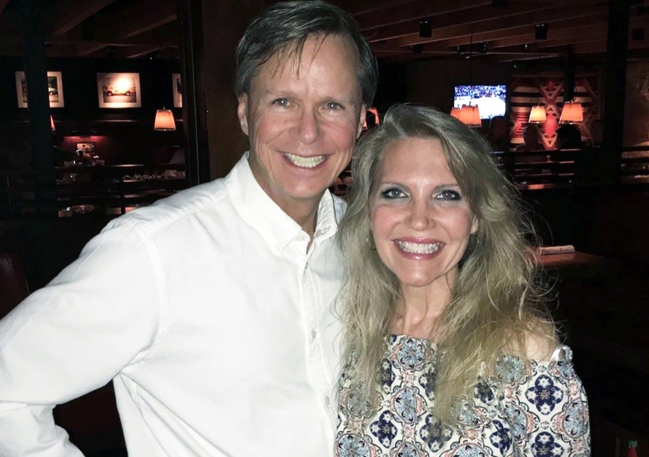 Anal cancer survivor Melissa Rickenbacher poses for the camera beside her husband, Gary Rickenbacher
