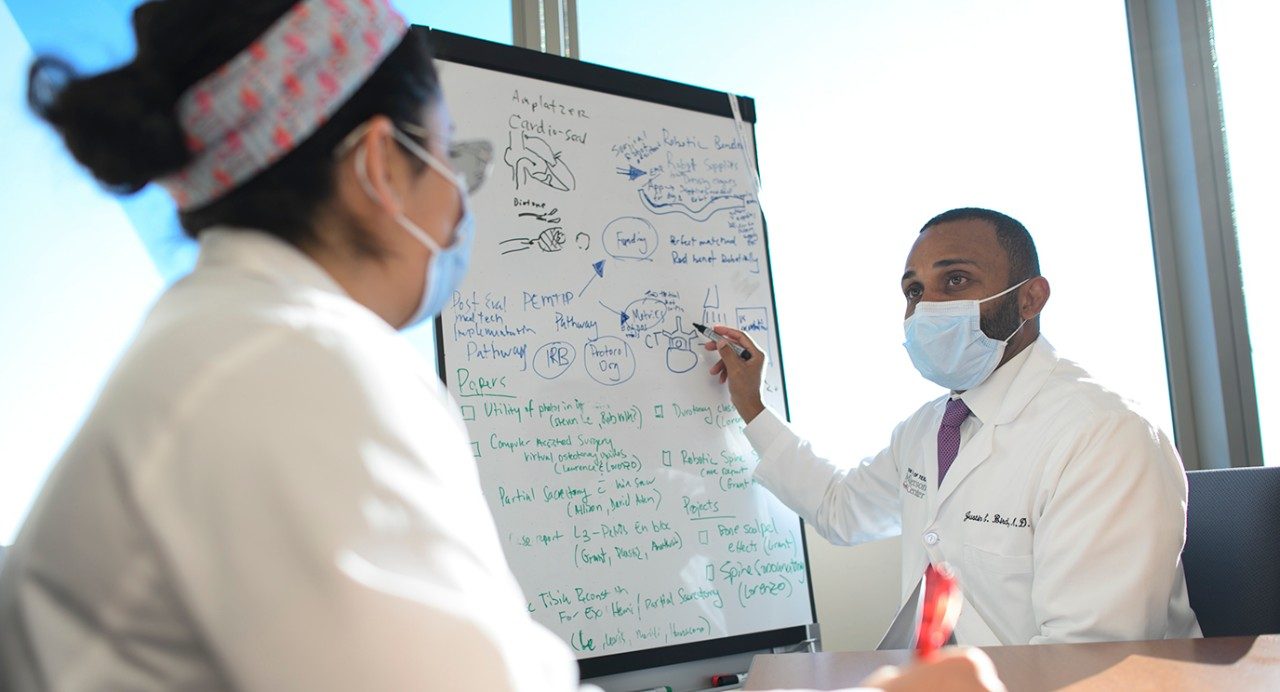 Justin Bird, M.D., speaks with his assistant, Krystal Kimiagaree
