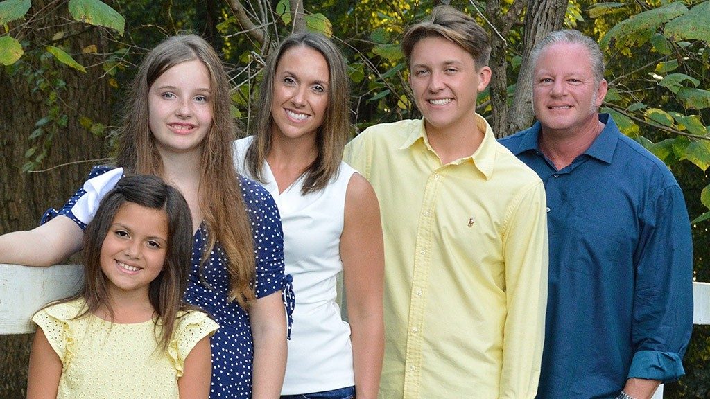 Leukemia survivor Lindsay McClure (center) poses with four members of her family
