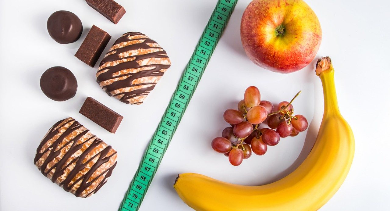 photo shows fruit on one side and candy and pastries on the other.