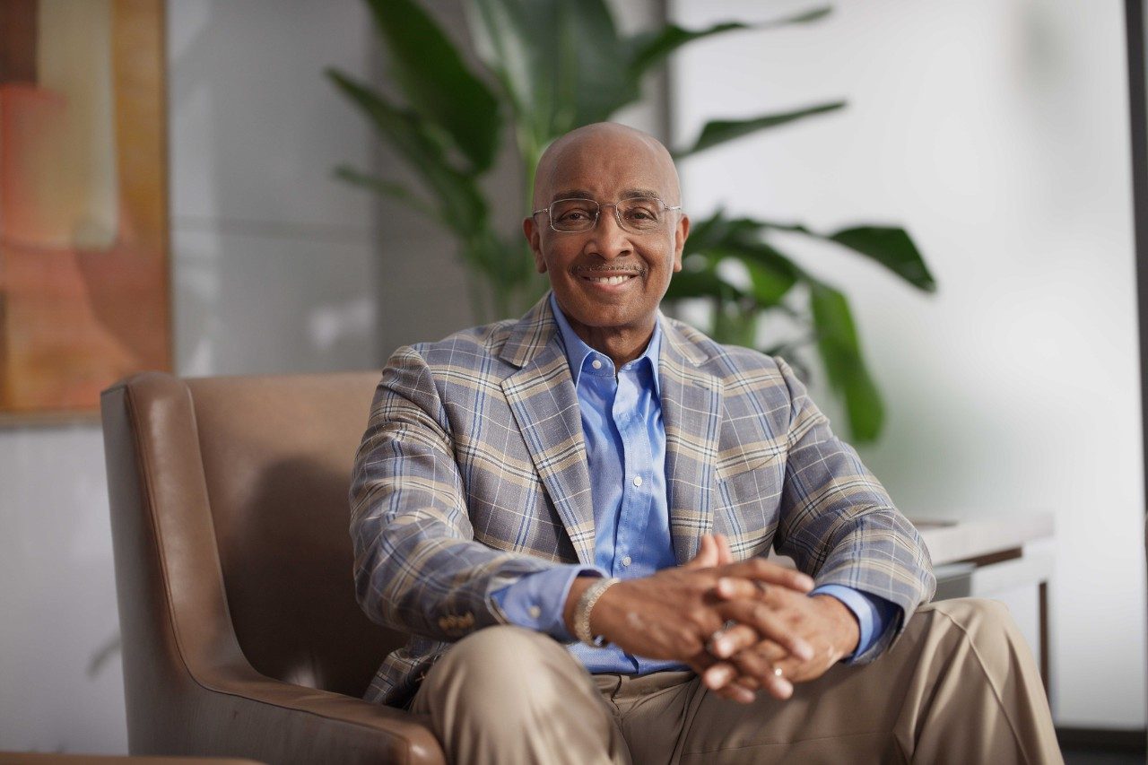 Stage IV oral cancer survivor D. Ivan Young, Ph.D. smiles at the camera. He is a middle-aged Black man.