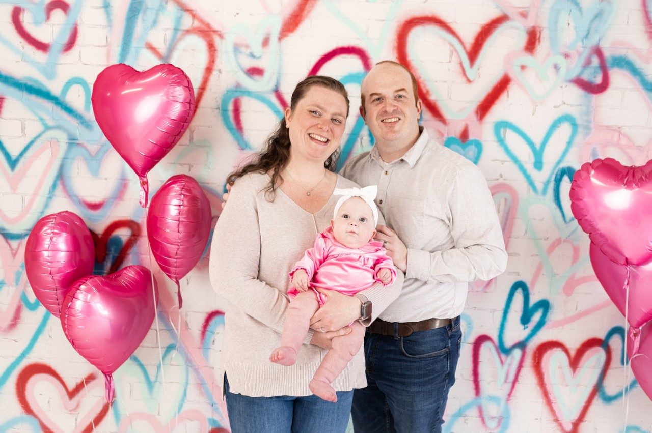 Brian Hertz and his wife, Jennifer, holding their baby daughter, Barrett