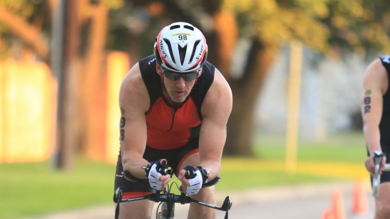 Chris Massanova riding a bicycle during a race.