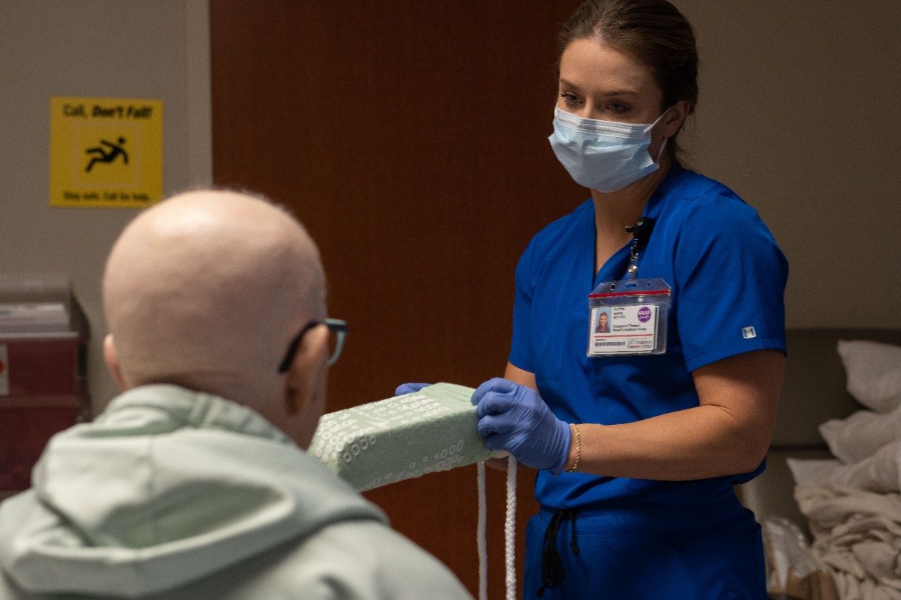 Orthopaedic Oncology's occupational therapist Sydney Ewing works with a cancer patient