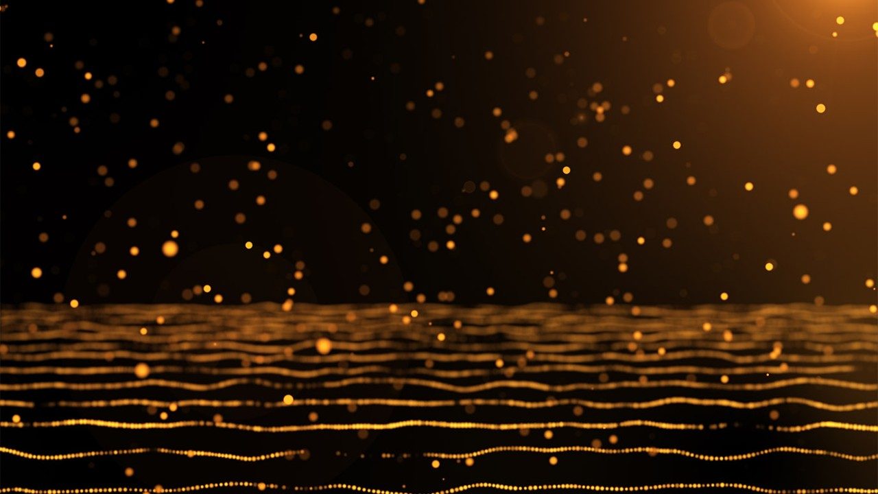 gold particles in a light with black background