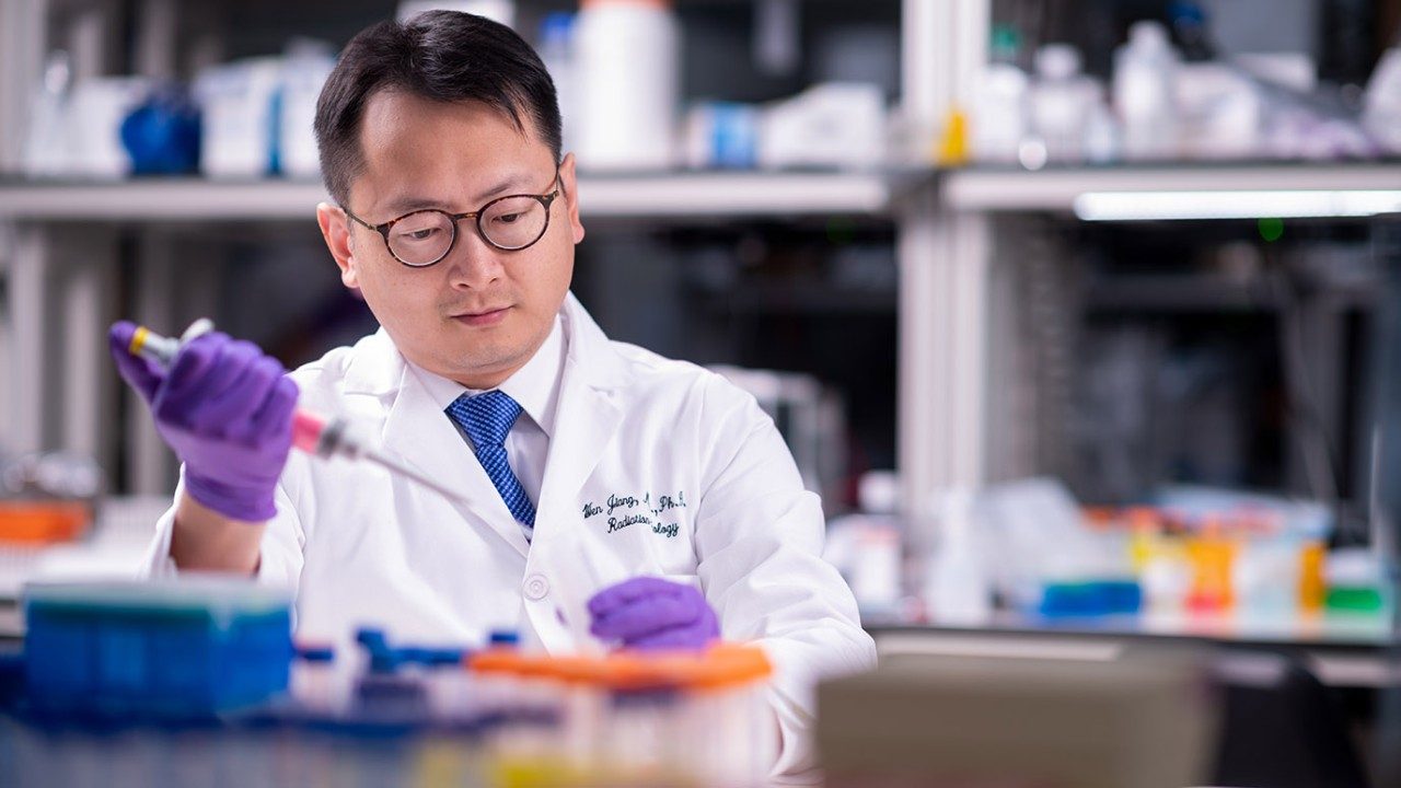 Wen Jiang, M.D., Ph.D., at work in his lab
