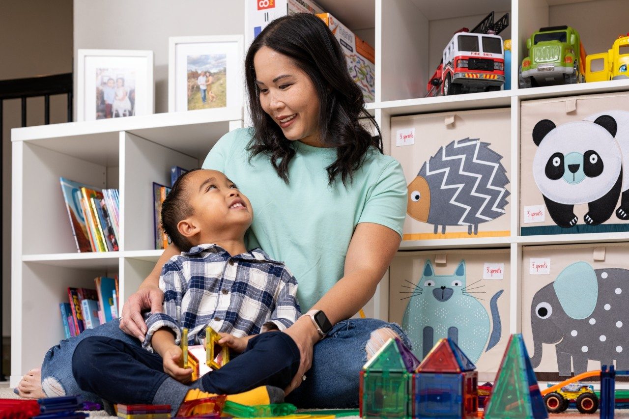 Lymphoma survivor Allie Moreno sits with her son surrounded by toys