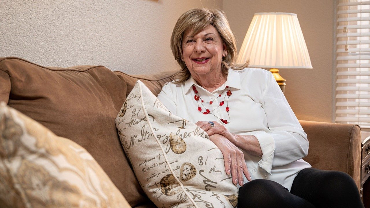 Non-Hodgkin lymphoma survivor Ann Sorhouse relaxes on her couch at home