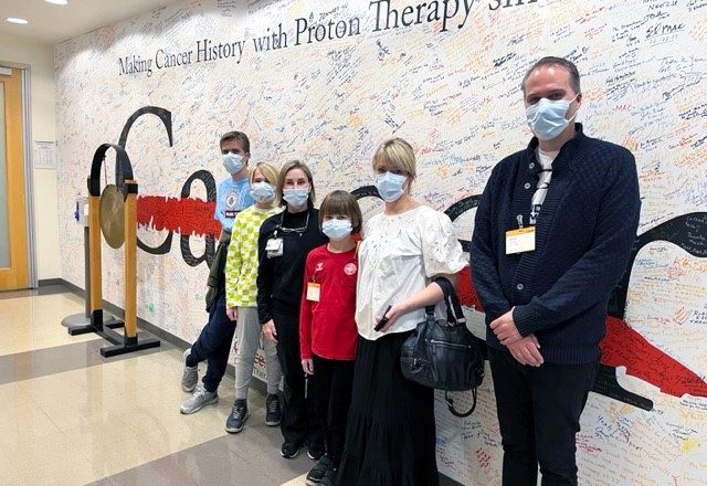 Lue Berghof and his family reunited with clinical nurse Yvette Rosenthal at MD Anderson Proton Therapy Center.
