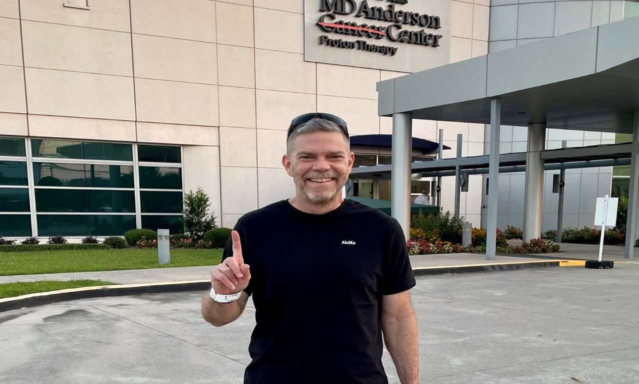 Judd Woehrle stands outside of the Proton Therapy Center at MD Anderson