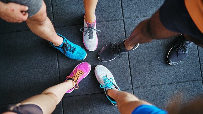 Bird's eye view of five sneakers on legs extended into a star-shape