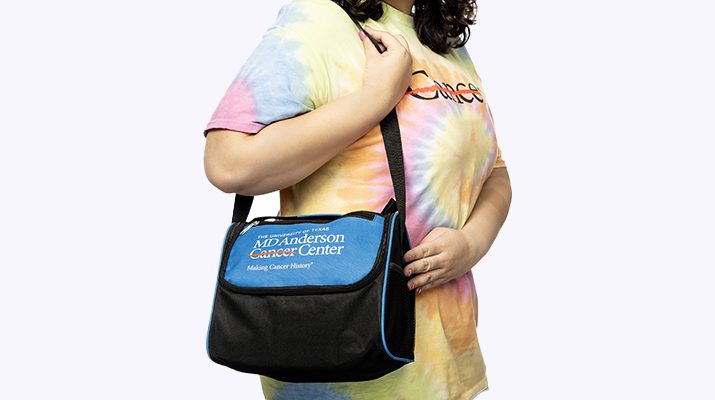 Blue and black lunch bag on woman's shoulder