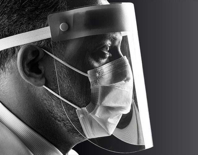 Side profile of Dr. Roy Chemaly wearing a mask and face shield