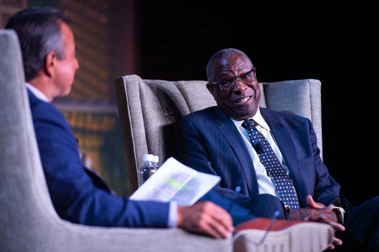 Dusty smiles while speaking with Todd Kalas on stage.