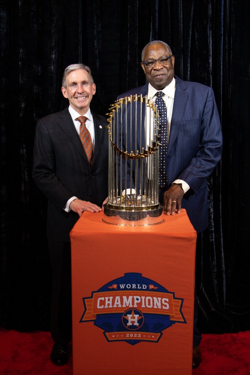 Peter WT Pisters, MD and Dusty Baker pose with the World Series trophy.