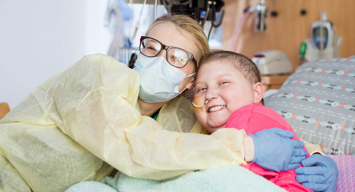 Pediatric acute lymphoblastic leukemia patient Kaylyn White hugging her mom, Leslie
