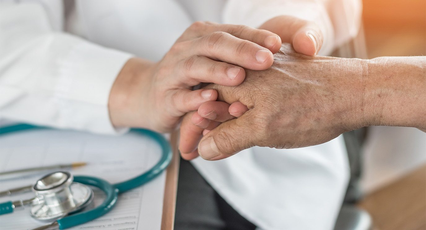 Doctor holding a patient's hand
