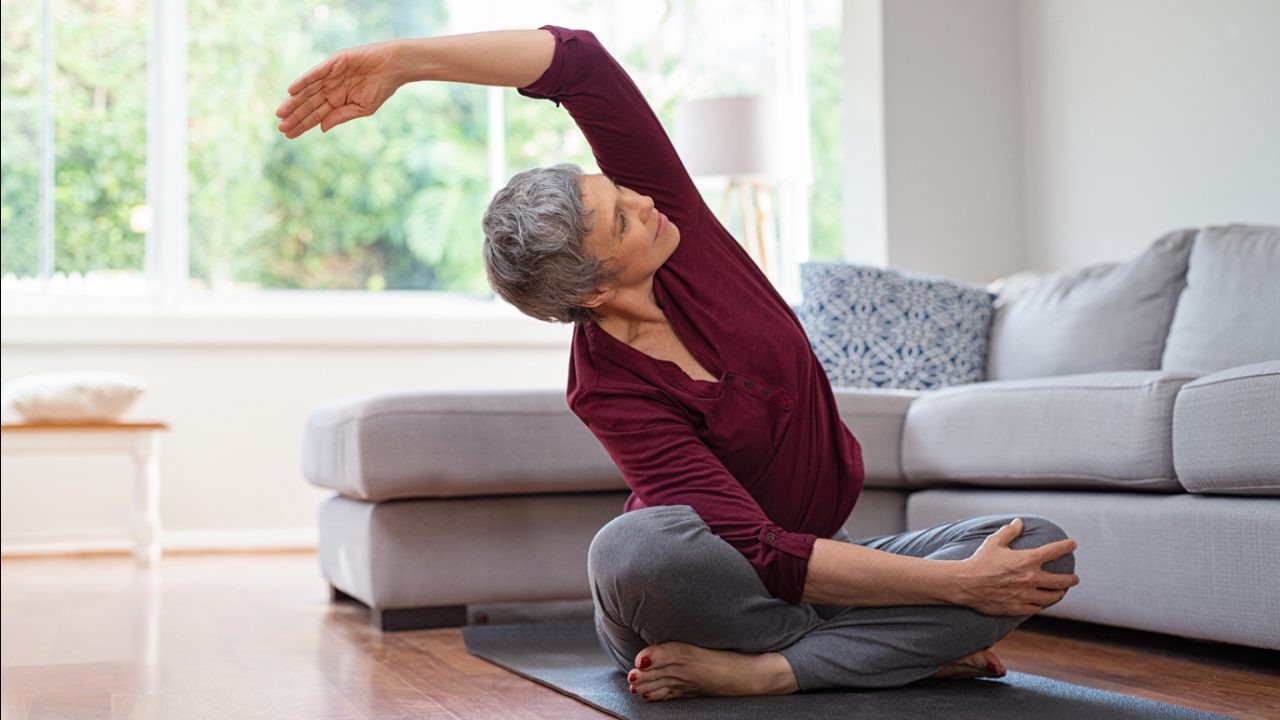 Woman stretches in her living room
