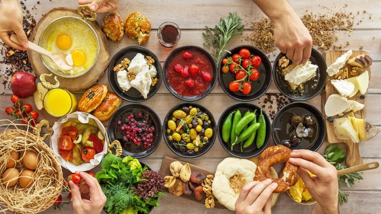 Small bowls seen from above, containing difference foods, mostly vegetables