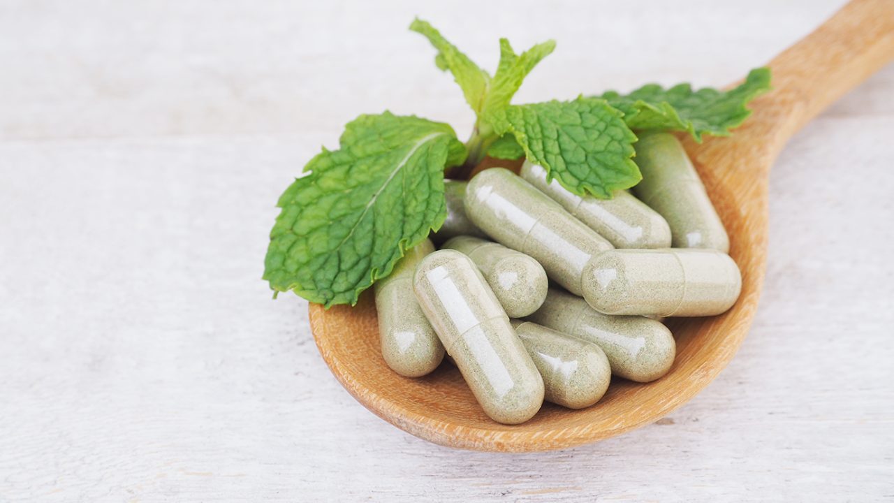 Supplements on wooden spoon