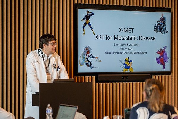 Dr. Ethan Ludmir speaking at a Radiation Oncology retreat.
