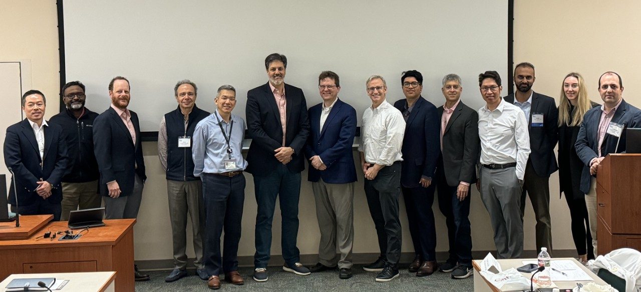 A group of 14 doctors poses for a group photo