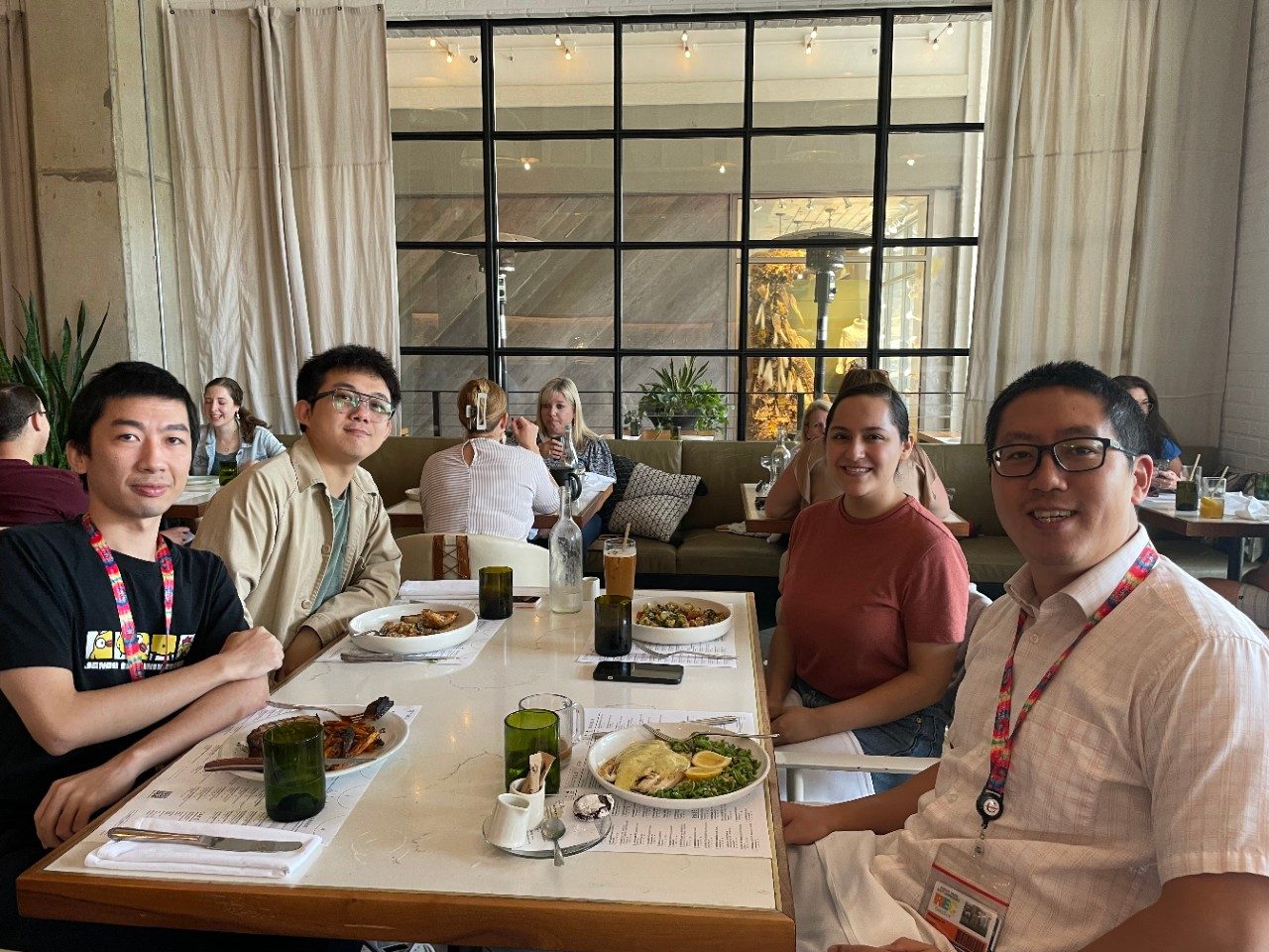 Four people seated around a table at a restaurant