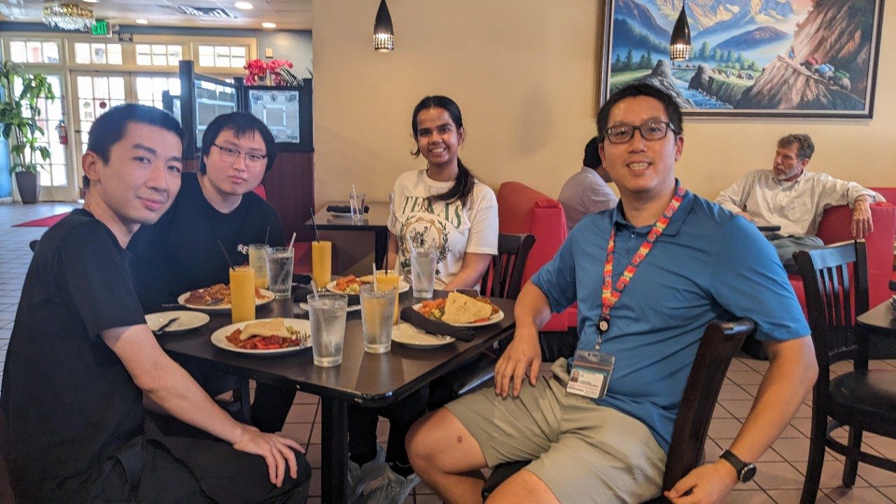 Four people seated around a table at a restaurant