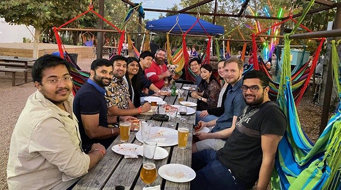 Huse lab members sit at a picnic table